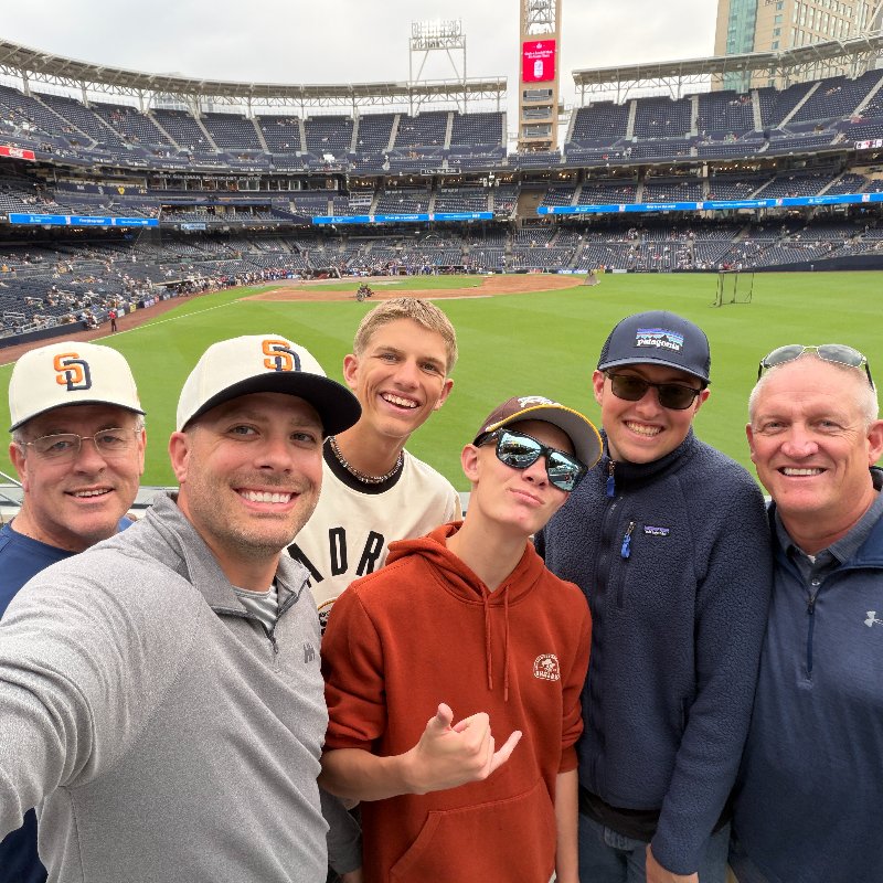 Preston of Pioneer Flooring with friends at a game