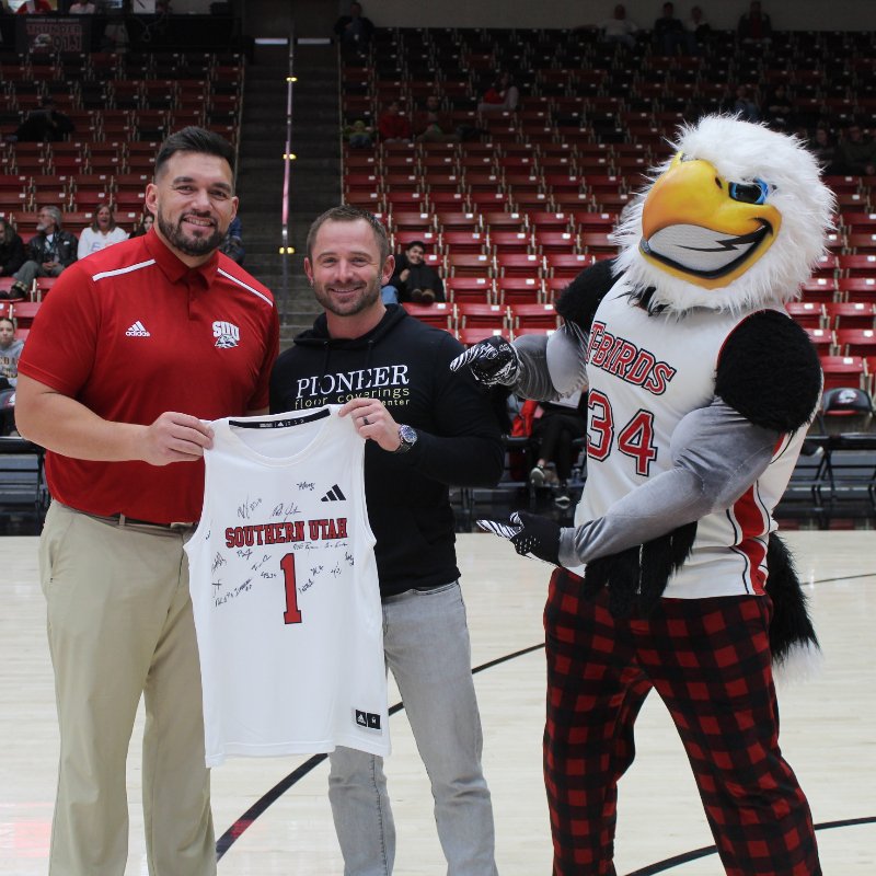 Glenn holding a Utah jersey