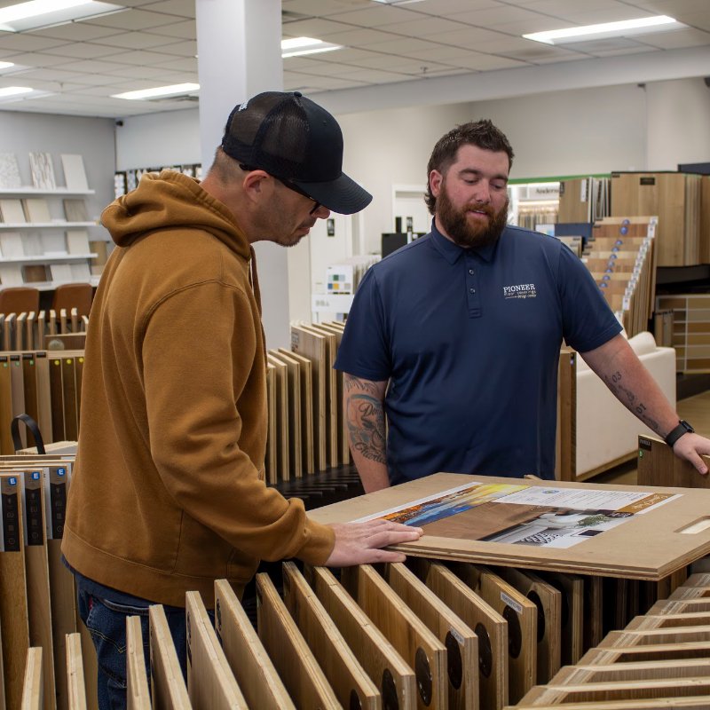 Browsing hardwood flooring in a Pioneer Flooring showroom