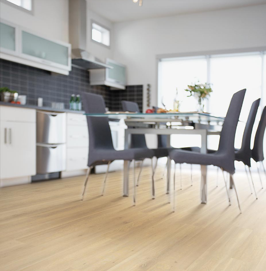 Light, natural wood-look laminate flooring adds brightness to a kitchen.