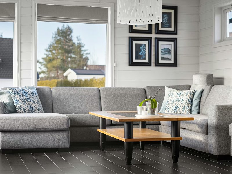 Living room with laminate flooring feature wall above fireplace
