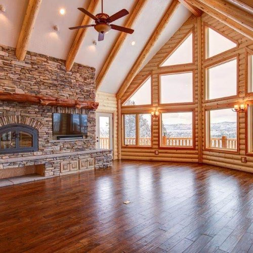 Rustic home with stone fireplace and hardwood flooring