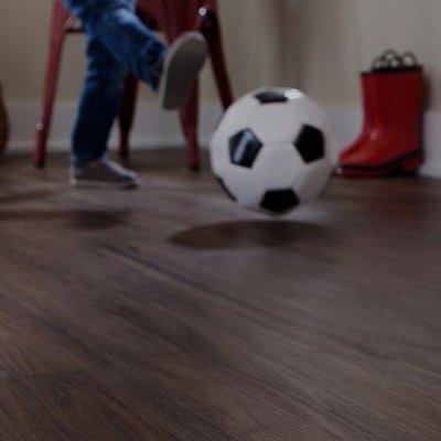 kid kicking soccer ball on durable TecWood Floors